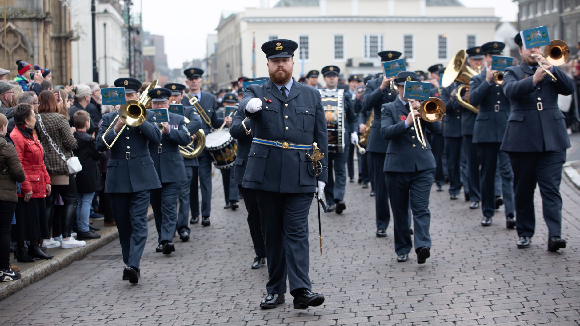 Image shows RAF band of musicians parading through town.
